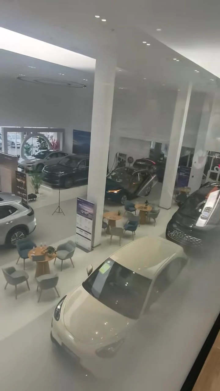 Electric sedans and SUVs parked on the partner dealership floor in Shanghai